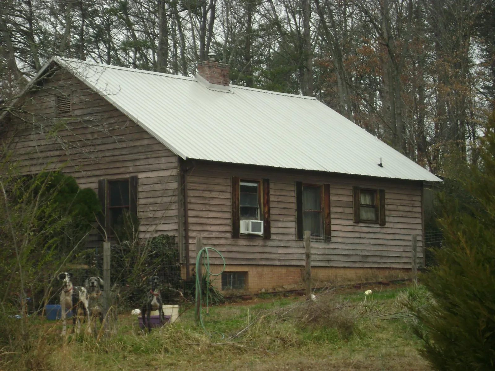 White metal roof on an old wood sided farmhouse, from a Metal Roof Installation job in Connellsville